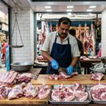 Experienced butcher in a Kolkata meat business preparing fresh same-day cut mutton