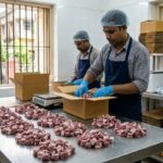 image of fresh raw mutton pieces being prepared for online delivery in a hygienic Kolkata setup with butcher and packaging